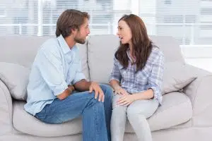 Young couple quarrelling in the office of therapist